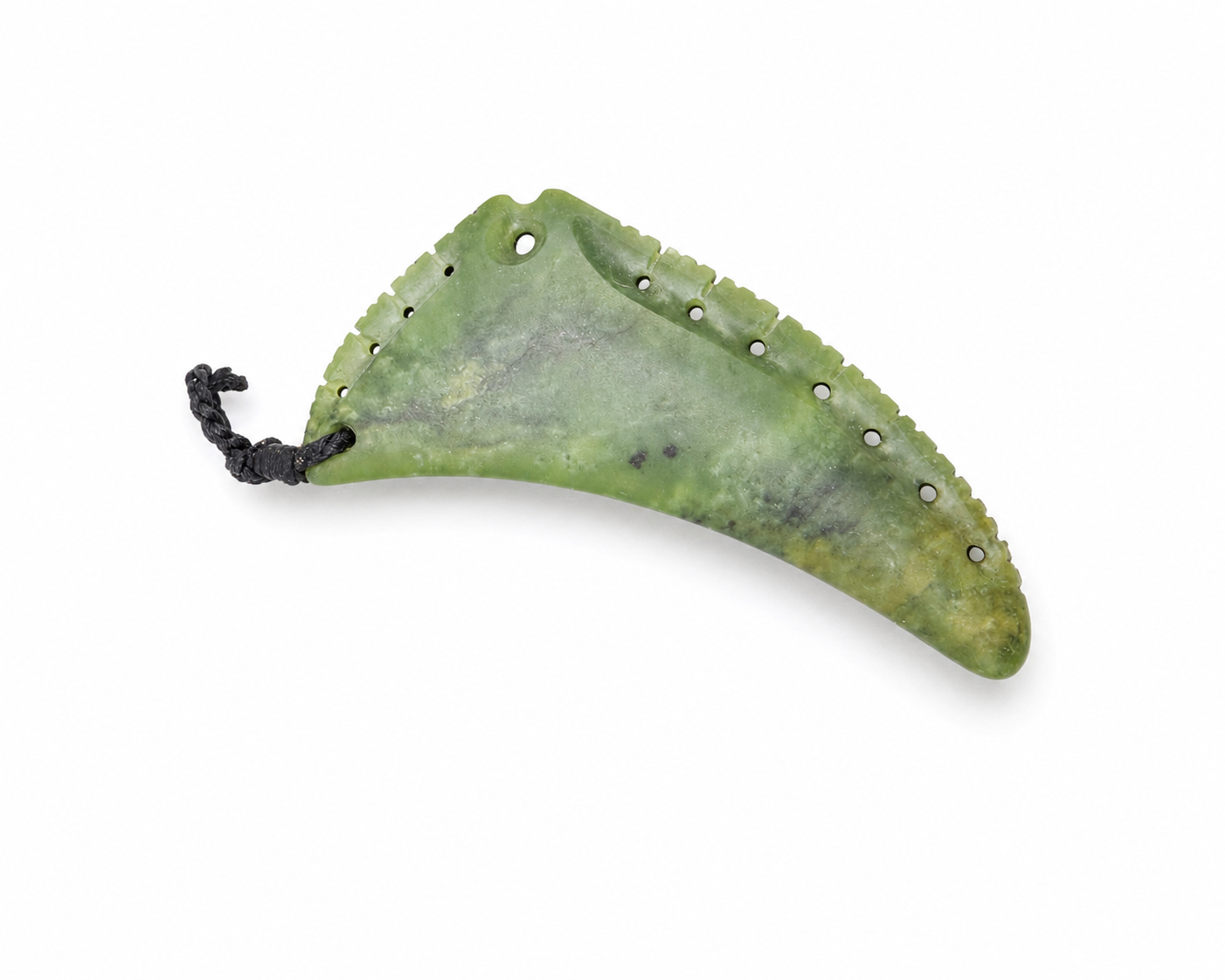 A green carved stone or jade pendant with a curved, leaf-like shape, featuring a serrated edge, several pre-drilled holes, and a black braided cord loop at one end, shown on a plain white background.