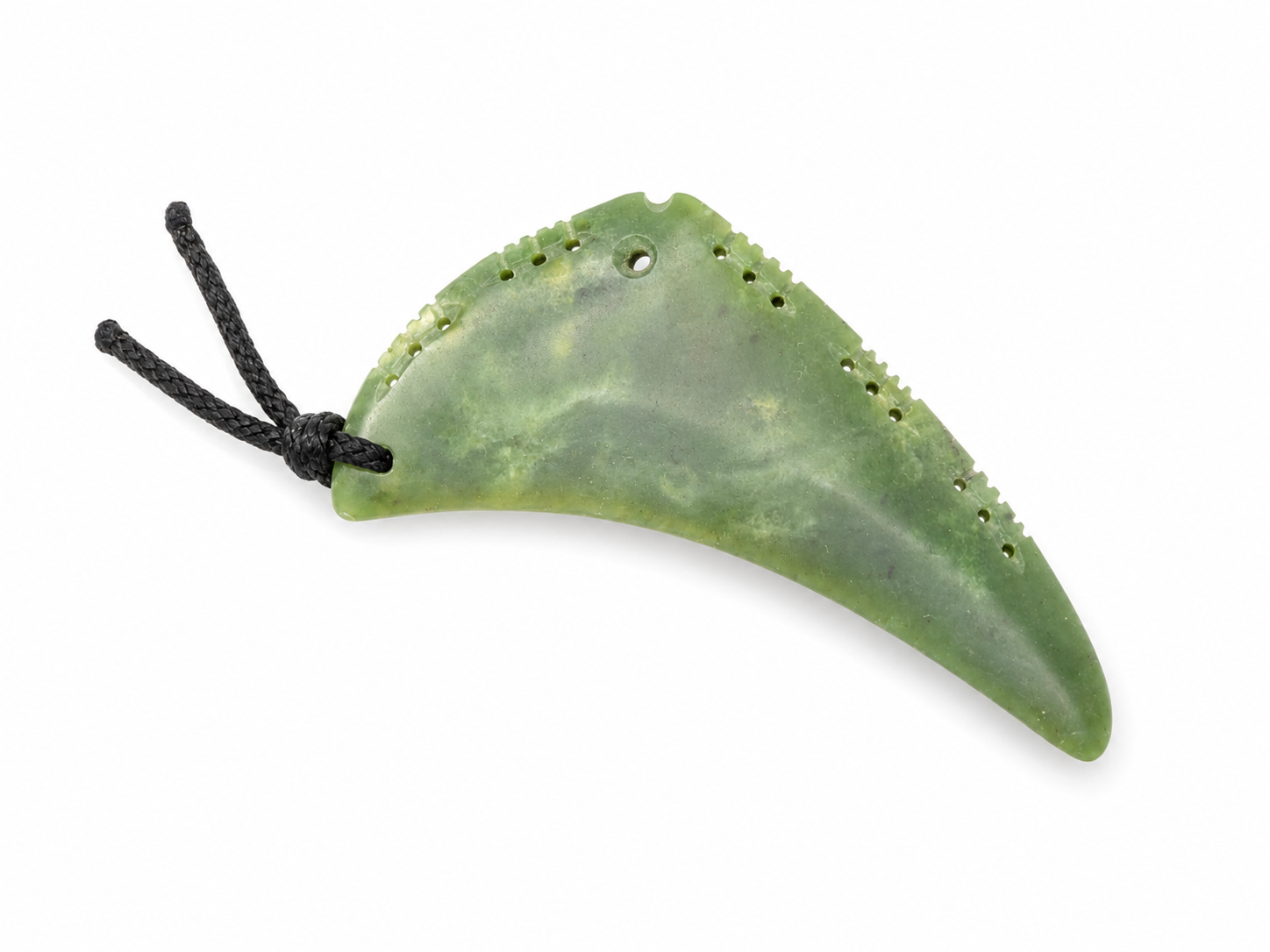 A green jade pendant shaped like a curved tooth with small cutouts along the edges and a black cord, shown on a plain white background.