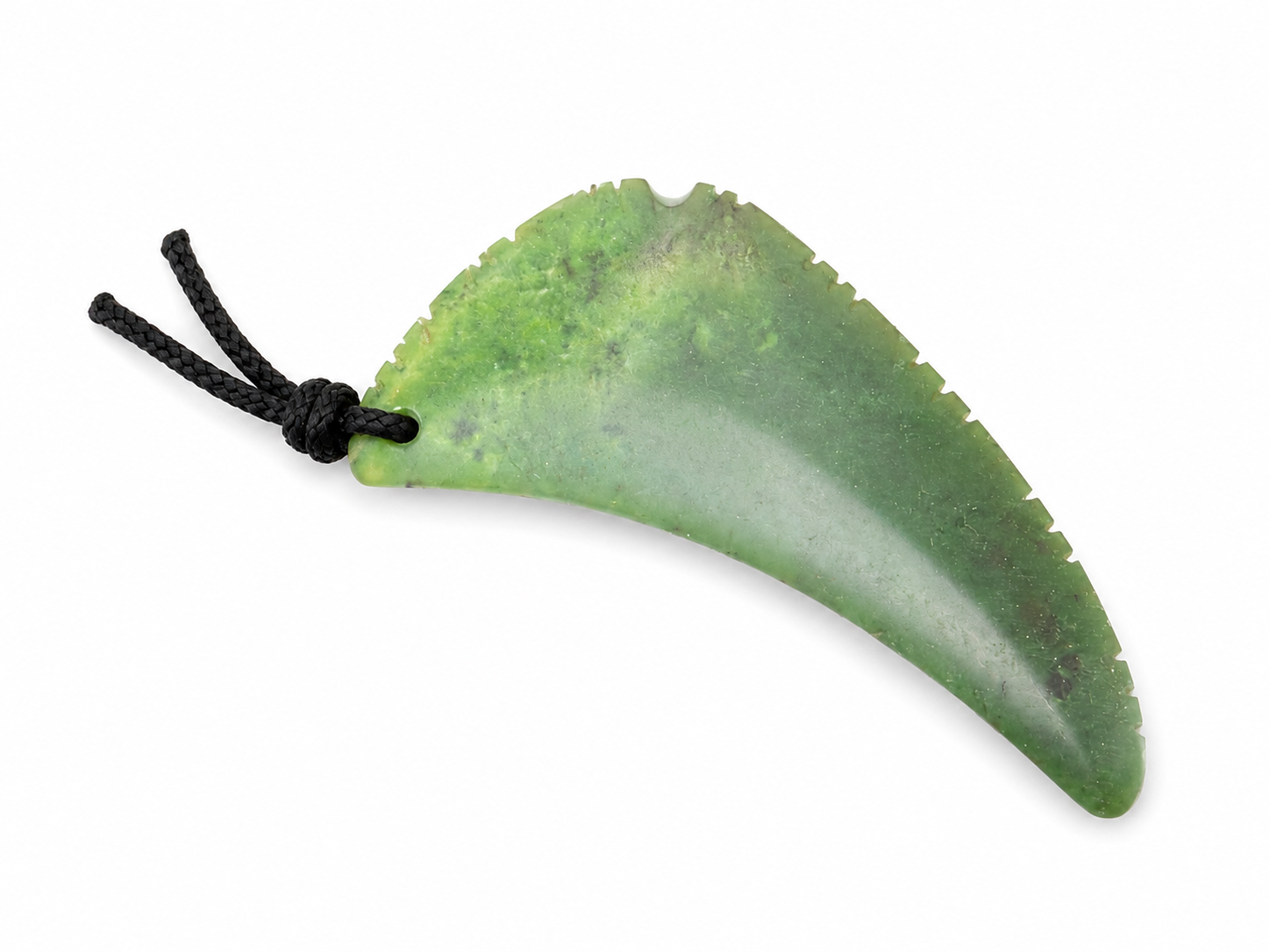 A green jade pendant shaped like a curved leaf with a black cord, shown on a plain white background.